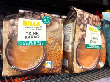 Villach, Austria - October 09, 2025: BILLA Trink Kakao cocoa drink mix packages are arranged on a supermarket shelf, highlighting their attractive design and rich flavor