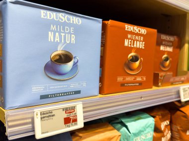 Villach, Austria - October 09, 2025: Eduscho coffee products are arranged on a store shelf, highlighting Milde Natur and Wiener Melange with vibrant packaging colors