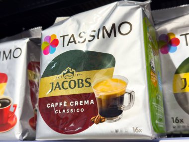 Villach, Austria - October 09, 2025: Tassimo coffee pods with Jacobs Caffe Crema Classico packaging are prominently displayed on a supermarket shelf, highlighting brand identity