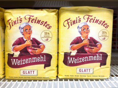 Villach, Austria - October 09, 2025: Fini's Feinstes Weizenmehl packaging displays a cheerful grandmother with bowl, emphasizing quality flour for baking needs
