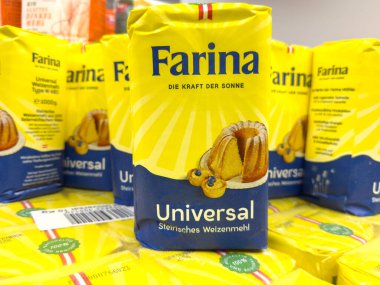 Villach, Austria - October 09, 2025: Farina Universal flour packaging is arranged in a grocery store, featuring vibrant yellow color and appealing design for baking lovers
