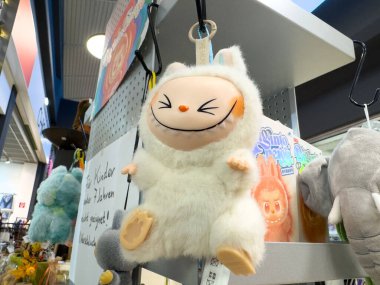 Villach, Austria - October 09, 2025: Adorable plush toy character with a smiling face displayed in a vibrant store, highlighting its playful design and cheerful ambiance