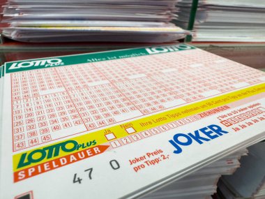 Villach, Austria - October 09, 2025: Lotto ticket displayed on a table with paper stacks, highlighting the thrill of lottery participation and potential winnings
