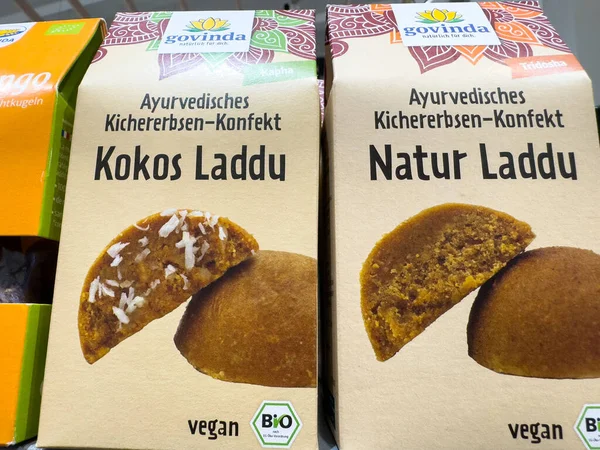 Villach, Austria - October 09, 2025: Vegan Ayurvedic chickpea sweets in attractive packaging, featuring Kokos Laddu and Natur Laddu, perfect for health-conscious consumers
