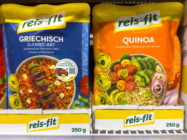 Villach, Austria - October 09, 2025: Reis-Fit food packages include Greek-style rice and quinoa, arranged on a supermarket shelf with bright colors and attractive graphics