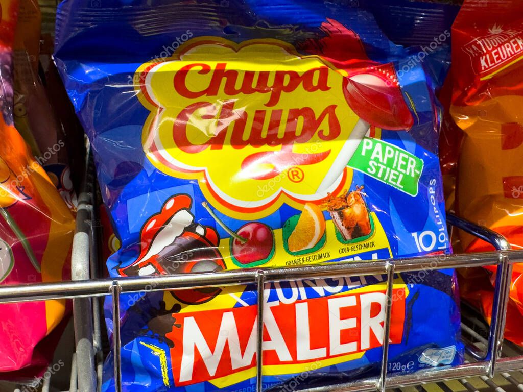 Villach, Austria - October 09, 2025: Chupa Chups candy packaging is prominently featured on a store shelf, highlighting its bright colors and fun design