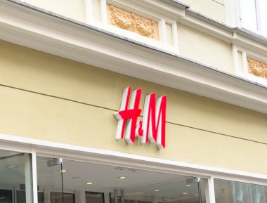 Ljubljana, Slovenia - October 10, 2025: H&M storefront features bold logo on light wall, inviting customers to discover stylish clothing and accessories