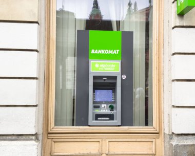 Ljubljana, Slovenia - October 10, 2025: ATM machine is prominently placed in a bank window, featuring green branding and modern design elements