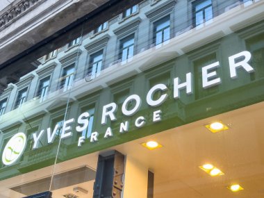 Trieste, İtalya - 14 Ekim 2025: Yves Rocher vitrininde marka logosu ve adı sergileniyor, camda kentsel mimariyi yansıtıyor, güzelliği ve doğayı vurguluyor