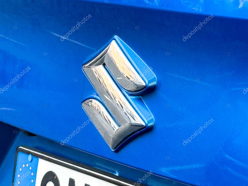 Trieste, Italy - October 14, 2025: Suzuki emblem featured on a blue vehicle, highlighting the brand's commitment to quality and innovation in automotive engineering