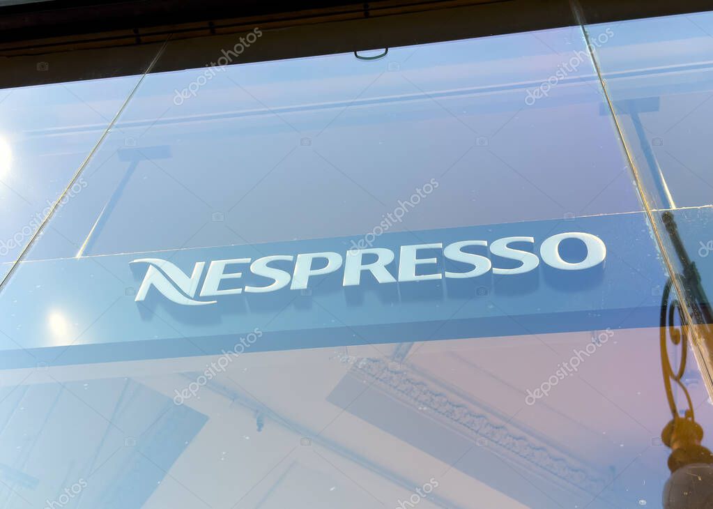 Trieste, Italy - October 14, 2025: Nespresso logo is featured on glass storefront, highlighting contemporary branding and urban ambiance