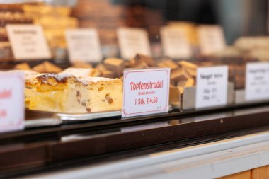 Villach, Avusturya - 08 Kasım 2025: Noel pazarındaki şenlikli hamur işleri Topfenstrudel ve çikolatalar, tatlı ikramlarla dolu sıcak bir tatil ortamı yaratıyor