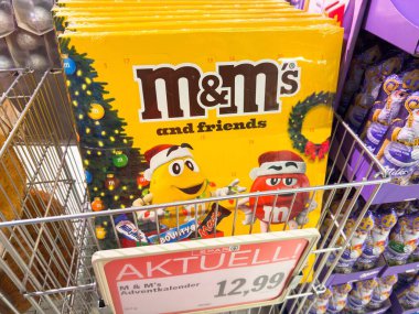 Villach, Avusturya - 25 Kasım 2025: M & M 'nin neşeli karakterleri bir mağazada sergilenerek festival renkleri ve bayram temalarını vurguluyor