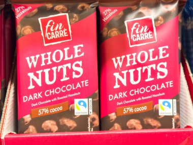 Bled, Slovenya - 17 Aralık 2025: Fin Carre Whole Nole Dark Chocolate ambalajı, canlı bir perakende rafında sunulan kakao ve fındıklı şekerleri ön plana çıkarıyor