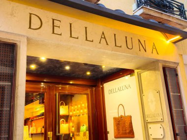 Venedik, İtalya - 05 Aralık 2025: DELLALUNA butiği lüks el çantaları ve moda tutkunları için aksesuarlarla aydınlatılmış davetkar bir giriş sunuyor