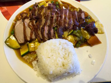 Sebzeli kızarmış ördek ve tabakta pilav..