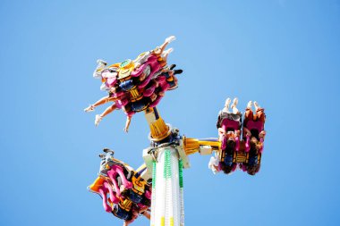 Avusturya 'nın Villach kenti - 29 Temmuz 2025: Heyecanlı bir eğlence gezisi, canlı bir festival atmosferinde yerden yüksekte asılı kalmanın heyecanını yaşayan sürücüler içindir.