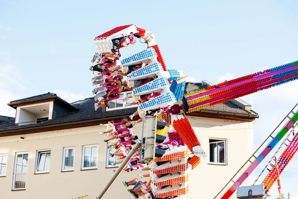 Villach, Avusturya - 29 Temmuz 2025: Festivalde renkli koltuklar ve neşeli sürücüler ile heyecanlı bir eğlence turu, kutlamanın canlı atmosferini vurguluyor