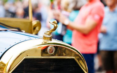 Velden, Avusturya - 30 Ağustos 2025: Detaylı bir figürle klasik araba kaput süsü, Eski Zaman Festivali 'nde kalabalık bir kalabalığın arasında, otomotiv tarihini kutluyor
