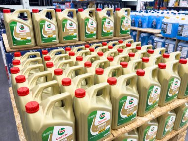 Ponte Nelle Alpi, İtalya - 27 Ocak 2026: Kırmızı kapaklı Castrol motor yağı şişeleri ahşap raflarda düzenli ve ilave ürünler görülebilir