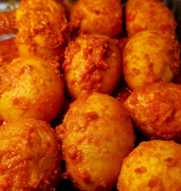 Close-up of telur balado, a traditional Indonesian spicy egg dish cooked with red chili sambal  authentic Asian comfort food and homemade cuisine