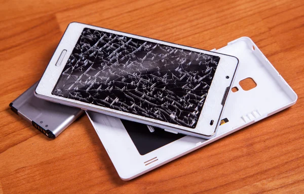 Opened broken white mobile phone with battery on wood ground — Stock Photo, Image