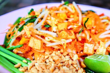 Otantik Lezzetli Tayland sokak yemekleri Tayland eriştesi karidesli soya fıstığı fasulyesi filizleri ve bir tabak limon.