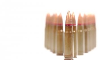 Ak-47 mühimmatı. Çapraz bir grup dik mermiden yukarı doğru eğilin. Beyaz arka planda son işlem.