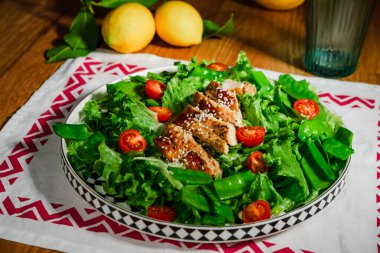 Akdeniz usulü salata, yeşil marul yaprağı, bezelye, ızgara tavuk eti, vişneli domates, zeytinyağıyla kaplanmış, bir porsiyon