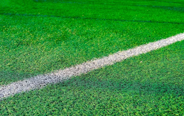 White stripe on green grass, on the football field. Football field with markings