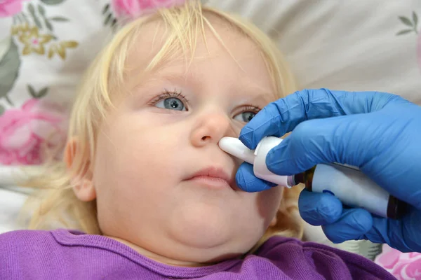 医生给一个病童的鼻子注射药物 — 图库照片