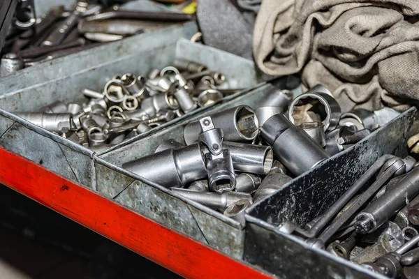 Locksmith wrenches and heads are in the repair cells at the auto repair shop.