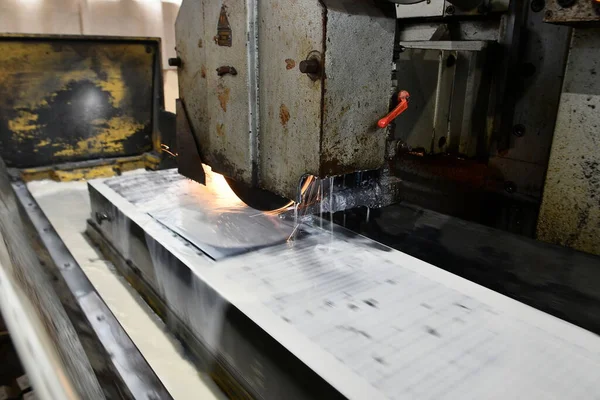 Processing and finishing of a metal plate on a surface grinding machine.