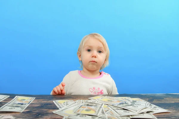 Angry and greedy child holds their money coins. The concept of greed, greed  and vice from childhood Photos