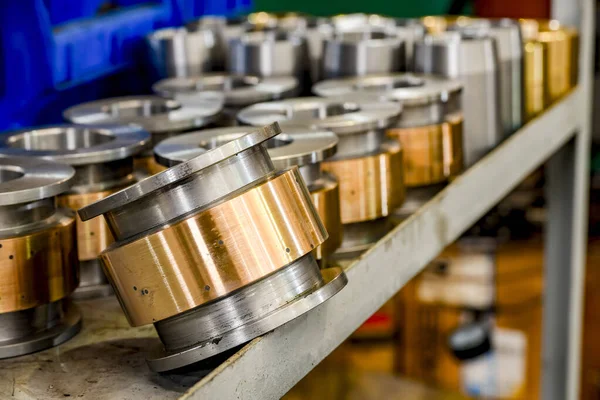 Hydraulic piston and cylinder on a rack in a warehouse.