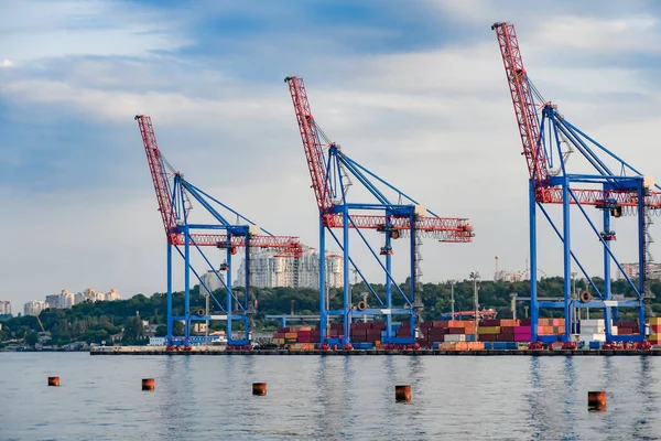 Cranes and industrial equipment in the sea, cargo port. View from the sea.