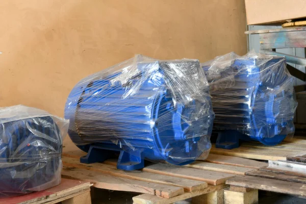 New electric motors are wrapped with packaging in the warehouse.