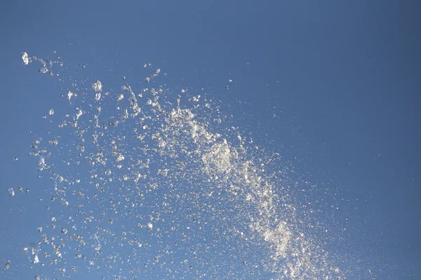 Water drops spraying from a fountain — Stock Photo, Image