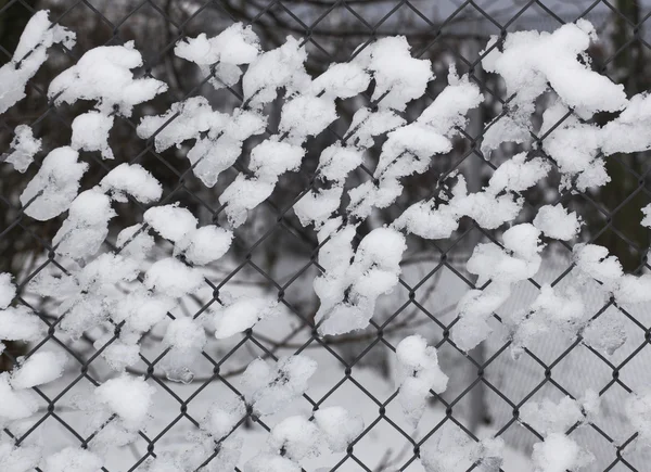 Fence with pieces of snow — Stock Photo, Image