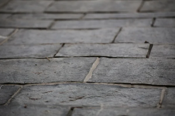 Solo pavimentado com efeito de desfocagem utilizável como fundo — Fotografia de Stock