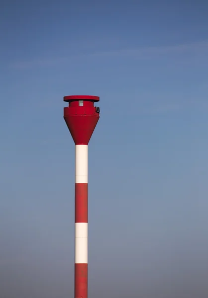 Modern red and white striped lighthouse on blue sky. Rostock — 스톡 사진