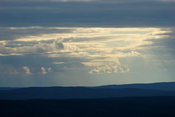 Diferentes tonos de azul y rayos de sol visto desde la montaña tiene — Foto de Stock