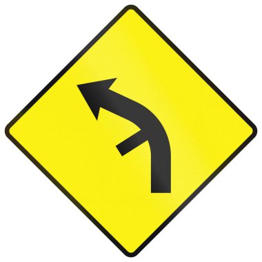 Uyarı işareti İrlanda 'da - Keskin viraj sola iç virajda yan yol kavşağı ile.