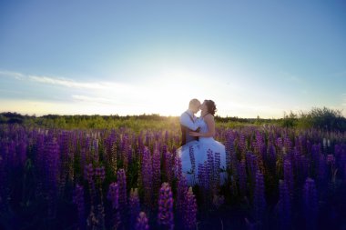 bride and groom hugging in lavender field