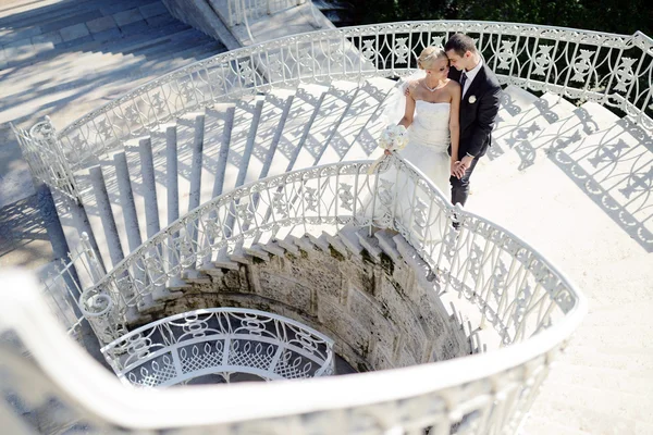 Bella coppia di nozze che si abbraccia sulle scale — Foto Stock