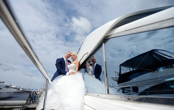 Wedding couple hugging on yacht