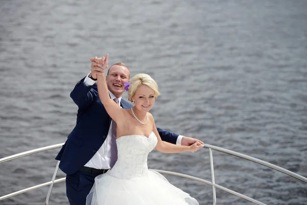 Wedding couple hugging on yacht