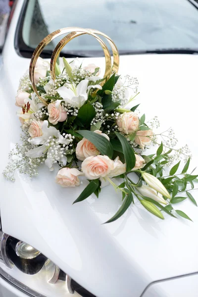 Wedding bouquet and rings on car Royalty Free Stock Images