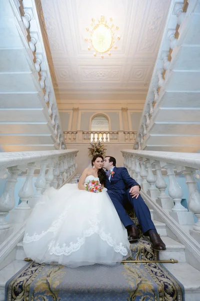 Wedding couple hugging on stairs — Stock Photo, Image