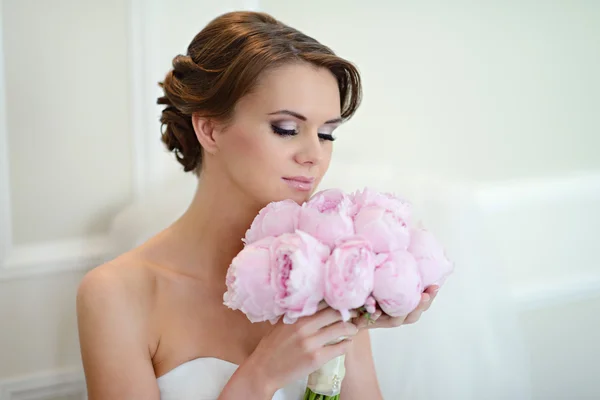 Hermosa novia en vestido de novia con ramo — Foto de Stock